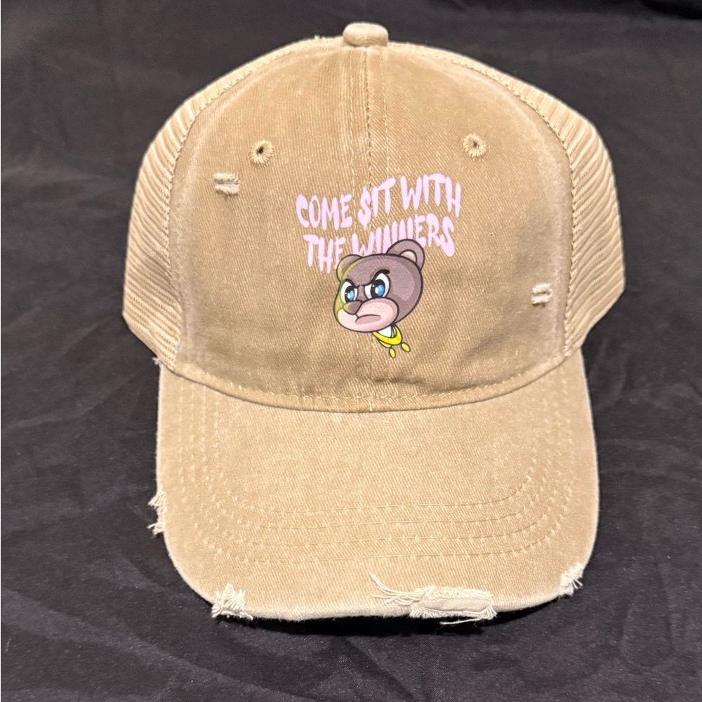 Tan distressed Cap with a stylish bear and pink graphic logo Design.